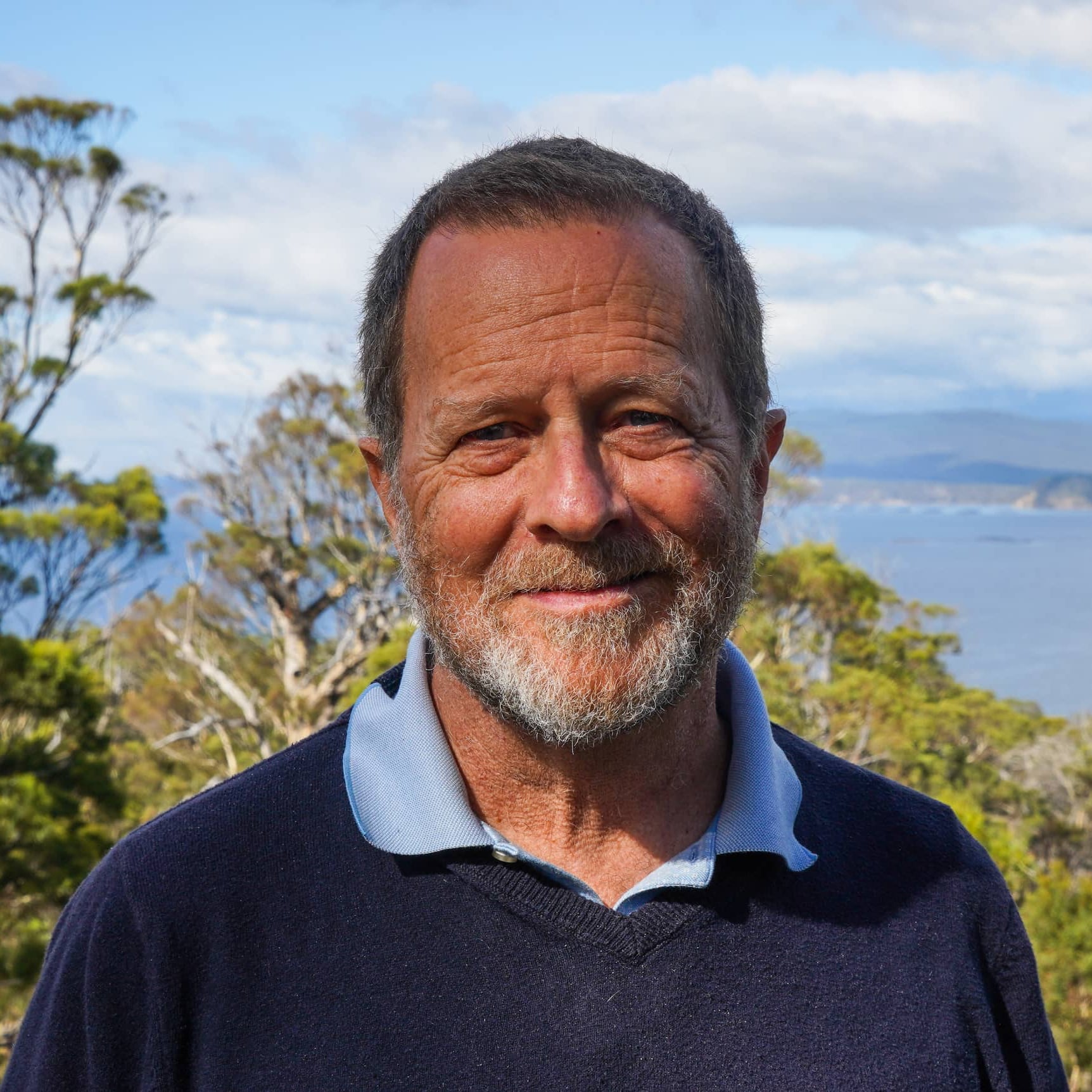 David Mason with bush and sea in background